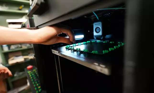 Alexis Strain, graduate student in biological sciences at Louisiana State University shows A 3D printer they are using to create biodegradable Mardi Gras beads, Jan. 27, 2026, in Baton Rouge, La. (AP Photo/Gerald Herbert)