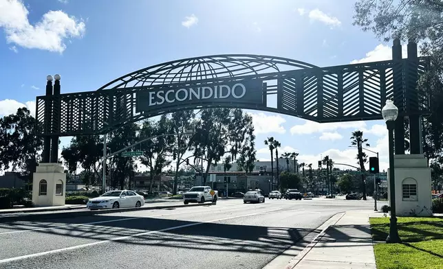 Motorists drive under a city sign on Wednesday, Feb. 18, 2026 in Escondido, Calif. (AP Photo/Amy Taxin)