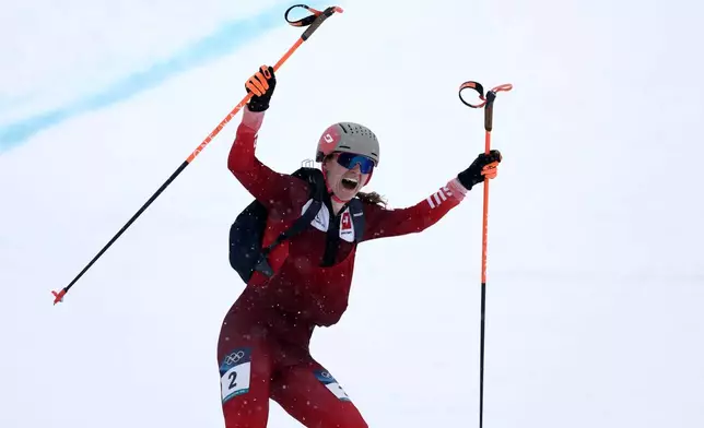 Switzerland's Marianne Fatton celebrates winning a ski mountaineering women's final at the 2026 Winter Olympics, in Bormio, Italy, Thursday, Feb. 19, 2026. (AP Photo/Gabriele Facciotti)