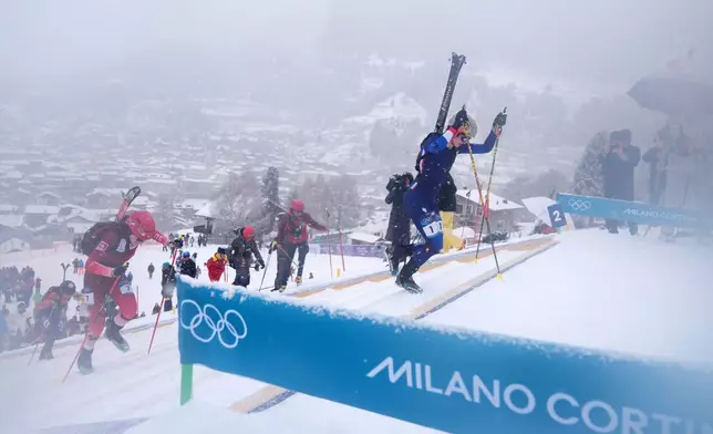 France's Emily Harrop leads during a ski mountaineering women's sprint heat, at the 2026 Winter Olympics, in Bormio, Italy, Thursday, Feb. 19, 2026. (AP Photo/Rebecca Blackwell)