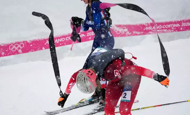 Switzerland's Marianne Fatton strips off her skins during a ski mountaineering women's semifinal at the 2026 Winter Olympics, in Bormio, Italy, Thursday, Feb. 19, 2026. (AP Photo/John Locher)
