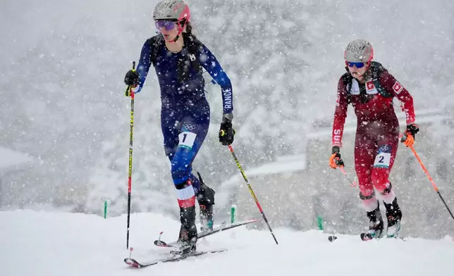 France's Emily Harrop, left, is followed by Switzerland's Marianne Fatton during a ski mountaineering women's semifinal at the 2026 Winter Olympics, in Bormio, Italy, Thursday, Feb. 19, 2026. (AP Photo/John Locher)