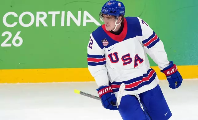 United States' Tage Thompson skates past the bench after scoring a goal against Slovakia during the first period of a men's ice hockey semifinal game at the 2026 Winter Olympics in Milan, Italy, Friday, Feb. 20, 2026. (AP Photo/Carolyn Kaster)
