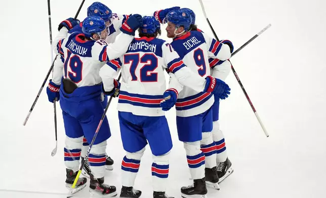 United States' Tage Thompson (72) celebrates with Matthew Tkachuk (19) and Jack Eichel (9) after Thompson scored against Slovakia during the first period of a men's ice hockey semifinal game at the 2026 Winter Olympics in Milan, Italy, Friday, Feb. 20, 2026. (AP Photo/Carolyn Kaster)