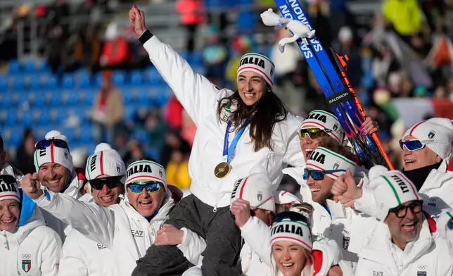 Gold medalist Lisa Vittozzi, of Italy, poses with teammates after the women's 10-kilometer pursuit biathlon race at the 2026 Winter Olympics in Anterselva, Italy, Sunday, Feb. 15, 2026. (AP Photo/Mosa'ab Elshamy)