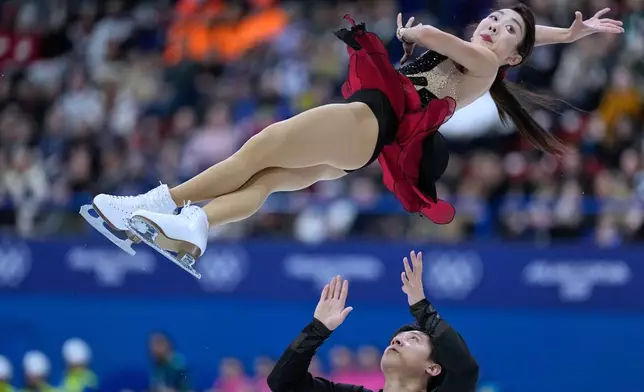 Sui Wenjing and Han Cong of China compete during the pairs figure skating short program at the 2026 Winter Olympics, in Milan, Italy, Sunday, Feb. 15, 2026. (AP Photo/Natacha Pisarenko)