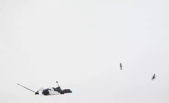 Finland's Elias Lajunen crashes during the men's freestyle skiing big air qualifications at the 2026 Winter Olympics, in Livigno, Italy, Sunday, Feb. 15, 2026. (AP Photo/Lindsey Wasson)