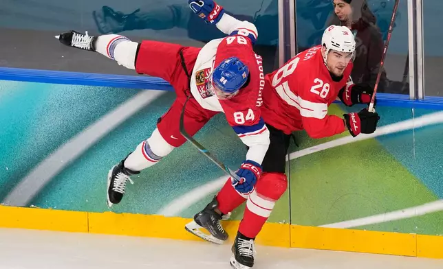 Czechia's Tomas Kundratek (84) challenges with Switzerland's Timo Meier (28) during a preliminary round match of men's ice hockey between Switzerland and Czechia at the 2026 Winter Olympics, in Milan, Italy, Sunday, Feb. 15, 2026. (AP Photo/Petr David Josek)