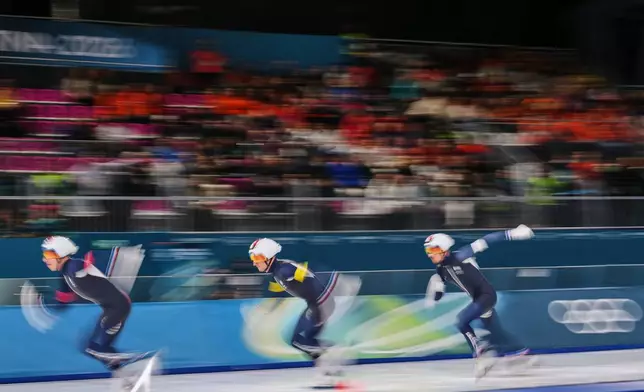 Team France with Germain Deschamps, white armband, Timothy Loubineaud, red armband, and Valentin Thiebault, yellow armband, compete in the men's team pursuit quarterfinals speedskating race at the 2026 Winter Olympics, in Milan, Italy, Sunday, Feb. 15, 2026. (AP Photo/Antonio Calanni)