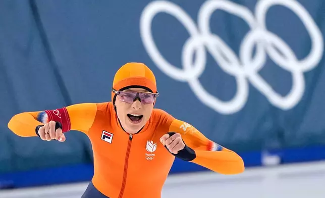 Femke Kok of the Netherlands celebrates winning the gold medal in the women's 500 meters speedskating race at the 2026 Winter Olympics, in Milan, Italy, Sunday, Feb. 15, 2026. (AP Photo/Ben Curtis)