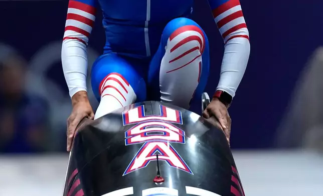 United States' Elana Meyers Taylor starts for a women's monobob run at the 2026 Winter Olympics, in Cortina d'Ampezzo, Italy, Sunday, Feb. 15, 2026. (AP Photo/Aijaz Rahi)