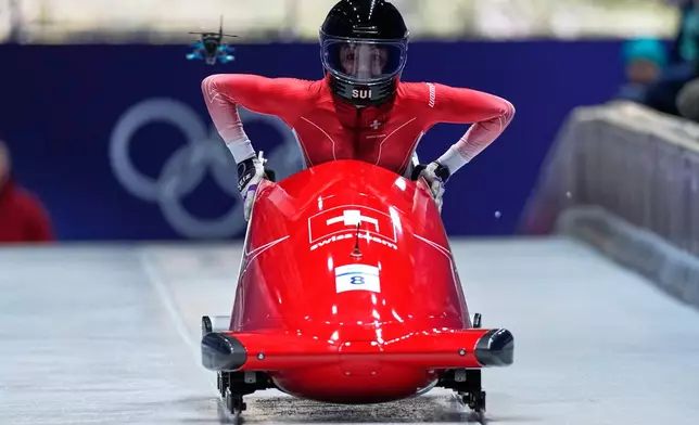 Switzerland's Melanie Hasler starts for a women's monobob run at the 2026 Winter Olympics, in Cortina d'Ampezzo, Italy, Sunday, Feb. 15, 2026. (AP Photo/Aijaz Rahi)