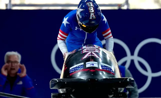 United States' Kaillie Armbruster Humphries starts for a women's monobob run at the 2026 Winter Olympics, in Cortina d'Ampezzo, Italy, Sunday, Feb. 15, 2026. (AP Photo/Aijaz Rahi)