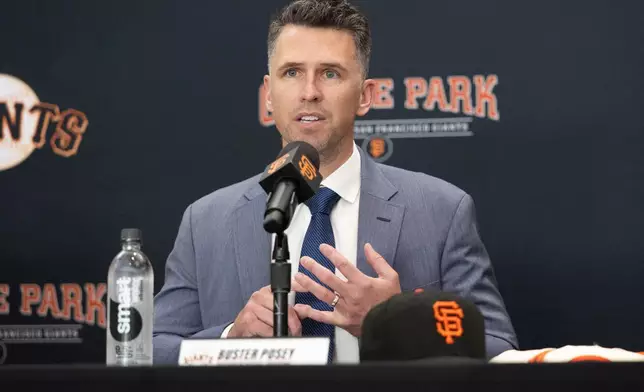 FILE -San Francisco Giants President of Baseball Operations Buster Posey sits during a press conference introducing Tony Vitello as the new manager of the San Francisco Giants baseball team on Oct. 30, 2025, in San Francisco. (AP Photo/Benjamin Fanjoy, File)
