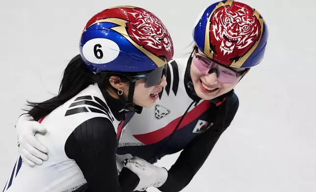 Kim Gilli and Choi Minjeong of Team Korea celebrate after winning gold during the short track speed skating women's team 3000m relay at the 2026 Winter Olympics, in Milan, Italy, Wednesday, Feb. 18, 2026. (AP Photo/Francisco Seco)