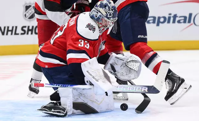 Washington Capitals goaltender Clay Stevenson (33) stops the puck during the second period of an NHL hockey game against the Carolina Hurricanes, Saturday, Jan. 31, 2026, in Washington. (AP Photo/Nick Wass)