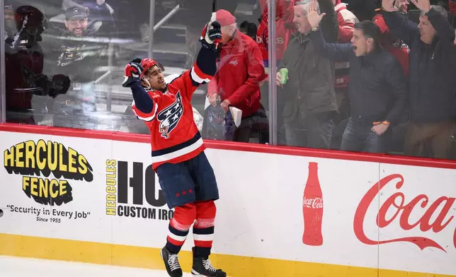 Washington Capitals right wing Justin Sourdif celebrates his game-wining goal in the overtime of an NHL hockey game against the Carolina Hurricanes, Saturday, Jan. 31, 2026, in Washington. (AP Photo/Nick Wass)