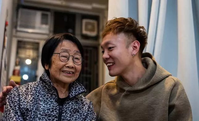 Pearl Chow, left, and Dorz Cheung, residents displaced by the deadly Wang Fuk Court fire speak during the interview at the transitional housing provided by the government in Hong Kong, Monday, Feb. 2, 2026. (AP Photo/Chan Long Hei)