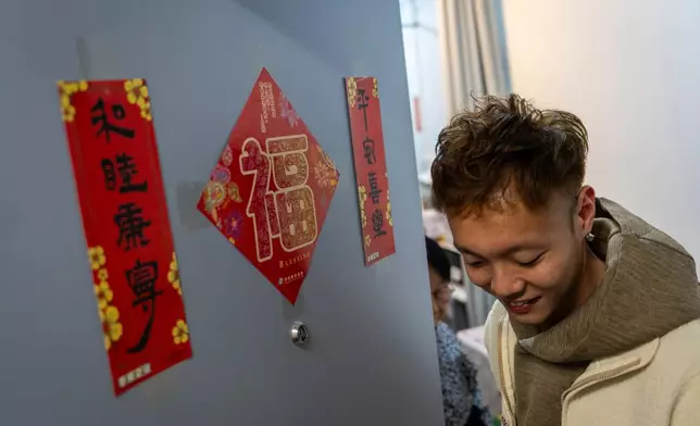 Lunar New Year's Fai Chun are hanged outisde the room of Dorz Cheung, a resident displaced by the deadly Wang Fuk Court fire, in Hong Kong, Monday, Feb. 2, 2026. (AP Photo/Chan Long Hei)