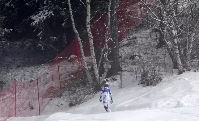 Norway's Atle Lie McGrath walks off the course after skiing out during an alpine ski, men's slalom race, at the 2026 Winter Olympics, in Bormio, Italy, Monday, Feb. 16, 2026. (AP Photo/John Locher)