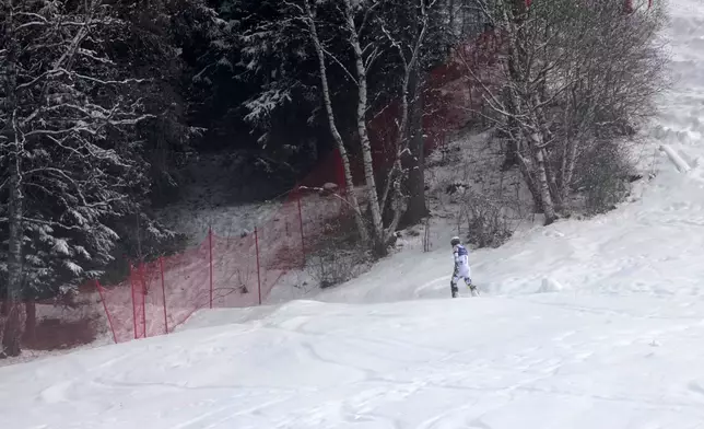 Norway's Atle Lie McGrath walks off the course after skiing out during an alpine ski, men's slalom race, at the 2026 Winter Olympics, in Bormio, Italy, Monday, Feb. 16, 2026. (AP Photo/John Locher)