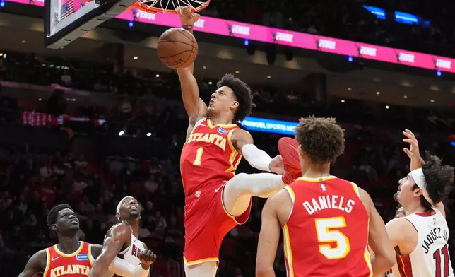Atlanta Hawks forward Jalen Johnson (1) dunks the ball during the first half of an NBA basketball game against the Miami Heat Tuesday, Feb. 3, 2026, in Miami. (AP Photo/Marta Lavandier)