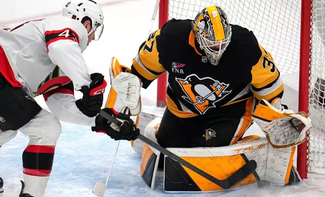 Pittsburgh Penguins goaltender Arturs Silovs (37) blocks a shot by Ottawa Senators' Tyler Kleven (43) during the first period of an NHL hockey game in Pittsburgh, Monday, Feb. 2, 2026. (AP Photo/Gene J. Puskar)