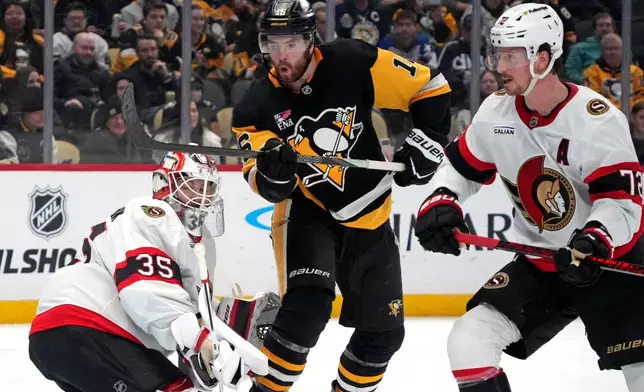 Pittsburgh Penguins' Justin Brazeau (16) screens Ottawa Senators goaltender Linus Ullmark (35) with Thomas Chabot, right, defending during the second period of an NHL hockey game in Pittsburgh, Monday, Feb. 2, 2026. (AP Photo/Gene J. Puskar)