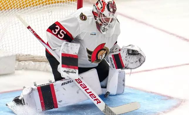 A shot by Pittsburgh Penguins' Egor Chinakhov (not shown) gets between the pads of Ottawa Senators goaltender Linus Ullmark for a goal scoring during the first period of an NHL hockey game in Pittsburgh, Monday, Feb. 2, 2026. (AP Photo/Gene J. Puskar)