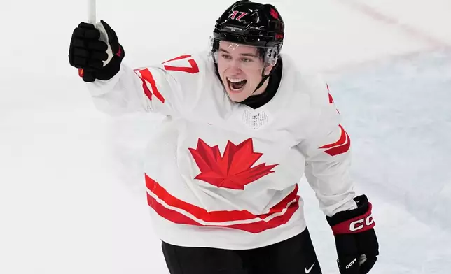 Canada's Macklin Celebrini celebrates after scoring his sides first goal during a preliminary round match of men's ice hockey between Czech Republic and Canada at the 2026 Winter Olympics, in Milan, Italy, Thursday, Feb. 12, 2026. (AP Photo/Petr David Josek)