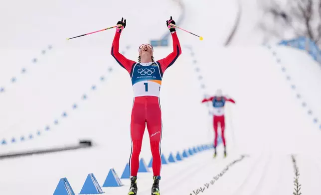 Johannes Hoesflot Klaebo, of Norway, approaches the finish line to win the gold medal in the cross country skiing men's 50km mass start Classic at the 2026 Winter Olympics, in Tesero, Italy, Saturday, Feb. 21, 2026. (AP Photo/Evgeniy Maloletka)