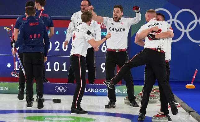 Canada's Brett Gallant, Brad Jacobs, Marc Kennedy and Ben Hebert celebrate defeating Britain in a men's curling gold medal match, at the 2026 Winter Olympics, in Cortina d'Ampezzo, Italy, Saturday, Feb. 21, 2026. (AP Photo/Fatima Shbair)