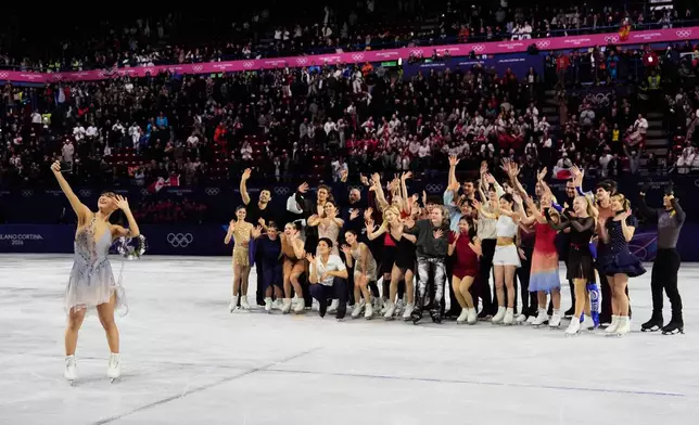 Athletes take a group selfie after performing in the figure skating exhibition at the 2026 Winter Olympics, in Milan, Italy, Saturday, Feb. 21, 2026. (AP Photo/Ashley Landis)