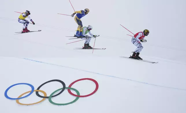 From left, Czechia's Daniel Paulus (27), Germany's Florian Fischer (14), Switzerland's Alex Fiva (11) and Switzerland's Ryan Regez (3) compete during the men's ski cross final at the 2026 Winter Olympics, in Livigno, Italy, Saturday, Feb. 21, 2026. (AP Photo/Abbie Parr)