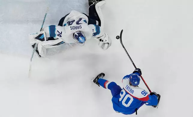 Slovakia's Tomas Tatar (90) scores his side's opening goal during a men's ice hockey bronze medal game between Slovakia and Finland at the 2026 Winter Olympics, in Milan, Italy, Saturday, Feb. 21, 2026. (AP Photo/Petr David Josek)