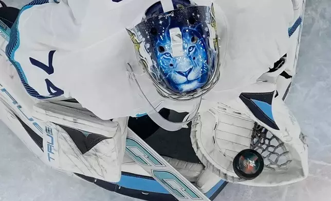 Finland's Juuse Saros (74) makes a save during a men's ice hockey bronze medal game between Slovakia and Finland at the 2026 Winter Olympics, in Milan, Italy, Saturday, Feb. 21, 2026. (AP Photo/Petr David Josek)