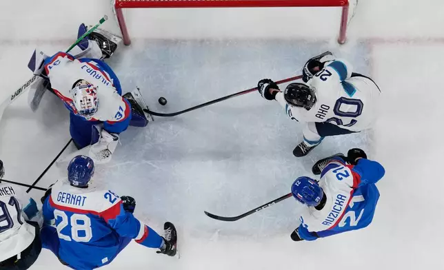 Finland's Sebastian Aho (20) scores his side's opening goal during a men's ice hockey bronze medal game between Slovakia and Finland at the 2026 Winter Olympics, in Milan, Italy, Saturday, Feb. 21, 2026. (AP Photo/Petr David Josek)