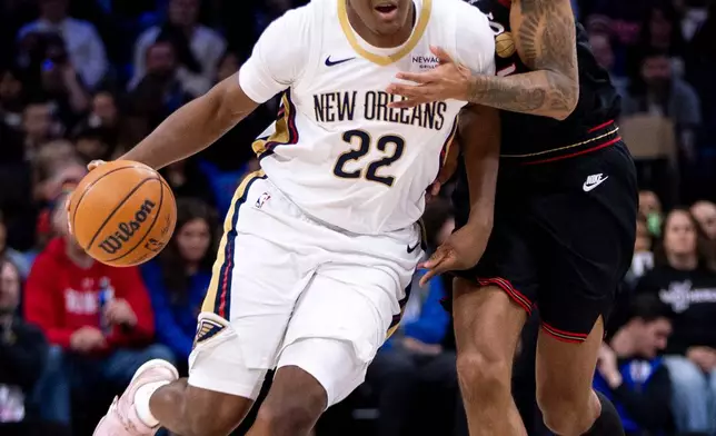 New Orleans Pelicans' Derik Queen, left, drives up the court against Philadelphia 76ers' Dom Barlow, right, during the first half of an NBA basketball game, Saturday, Jan. 31, 2026, in Philadelphia. (AP Photo/Chris Szagola)