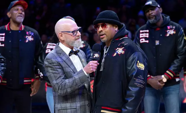 Allen Iverson, right, is interviewed by former team announcer Marc Zumoff, left, as Philadelphia 76ers honor the 2000-01 76ers team at halftime of an NBA basketball game against the New Orleans Pelicans, Saturday, Jan. 31, 2026, in Philadelphia. (AP Photo/Chris Szagola)