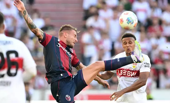FILE - Bologna's Ciro Immobile, left, in a duel with Stuttgart's Luca Jaquez during their pre-season friendly soccer match in Stuttgart, Germany, Saturday, Aug. 9, 2025. (Bernd Weissbrod/dpa via AP, File)