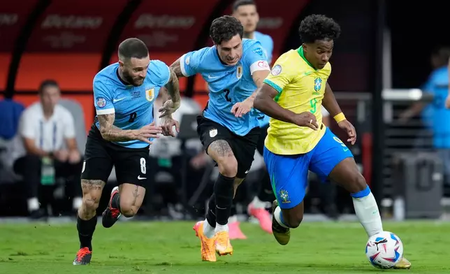 FILE - Brazil's Endrick, right, dribbles the ball followed by Uruguay's Nahitan Nandez, left, and Jose Gimenez during a Copa America quarterfinal soccer match in Las Vegas, Saturday, July 6, 2024. (AP Photo/Godofredo A. Vásquez, File)