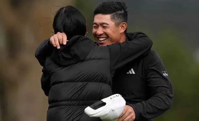 Collin Morikawa, right, celebrates with his wife, Katherine Zhu, after making a birdie putt on the 18th hole at Pebble Beach Golf Links during the final round to win the AT&amp;T Pebble Beach Pro-Am golf tournament in Pebble Beach, Calif., Sunday, Feb. 15, 2026. (AP Photo/Godofredo A. Vásquez)