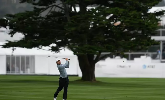 Min Woo Lee, from Australia, hits from the 18th fairway at Pebble Beach Golf Links during the final round of the AT&amp;T Pebble Beach Pro-Am golf tournament in Pebble Beach, Calif., Sunday, Feb. 15, 2026. (AP Photo/Godofredo A. Vásquez)