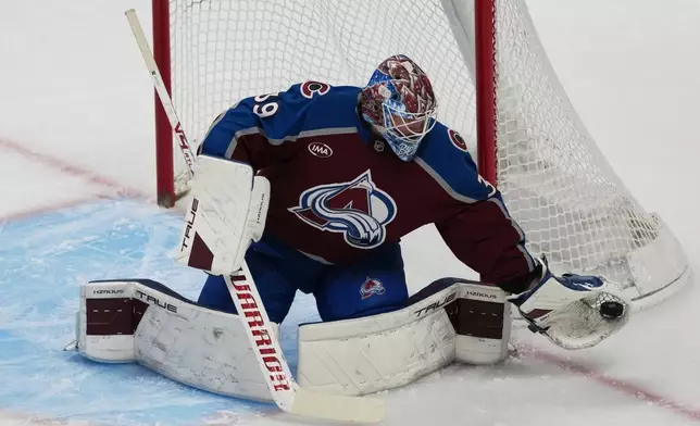 Colorado Avalanche goaltender MacKenzie Blackwood makes a glove-save in the first period of an NHL hockey game against the Detroit Red Wings, Monday, Feb. 2, 2026, in Denver. (AP Photo/David Zalubowski)