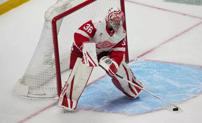 Detroit Red Wings goaltender John Gibson clears the puck in the first period of an NHL hockey game against the Colorado Avalanche, Monday, Feb. 2, 2026, in Denver. (AP Photo/David Zalubowski)