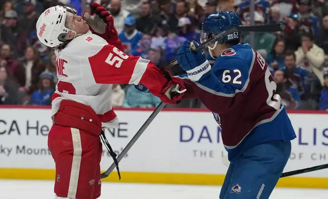 Detroit Red Wings center Emmitt Finnie, left, reacts after getting hit in the face by Colorado Avalanche left wing Artturi Lehkonen in the second period of an NHL hockey game, Monday, Feb. 2, 2026, in Denver. (AP Photo/David Zalubowski)