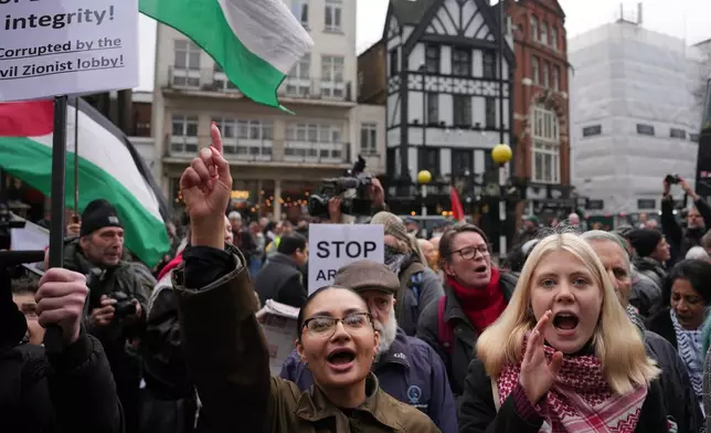 Supporters of Palestine Action stage a protest outside the Royal Court of Justice in London, Friday, Feb. 13, 2026. (AP Photo/Kin Cheung)