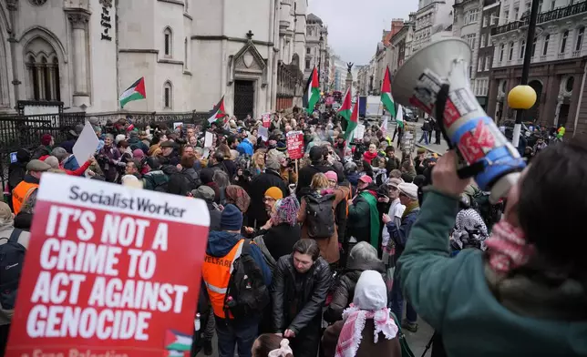 Supporters of Palestine Action stage a protest outside the Royal Court of Justice in London, Friday, Feb. 13, 2026. (AP Photo/Kin Cheung)