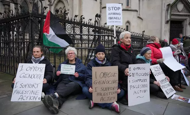 Supporters of Palestine Action stage a protest outside the Royal Court of Justice in London, Friday, Feb. 13, 2026. (AP Photo/Kin Cheung)