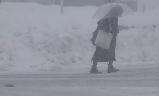 A person walks in a snow in Nagaoka, Niigata prefecture, Japan, on Jan. 22, 2026. (Chiaki Ueda/Kyodo News via AP)